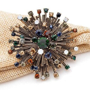 Multicolor rhinestone flower brooch with central dark green stone and sparkling petals