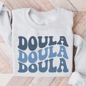 Light gray doula sweatshirt with stacked DOULA lettering on front