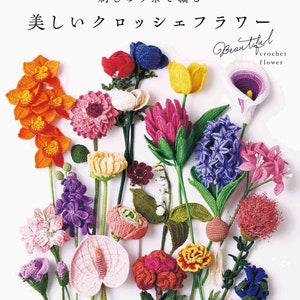 Crochet flower pattern book with assorted colorful crocheted flower designs laid out