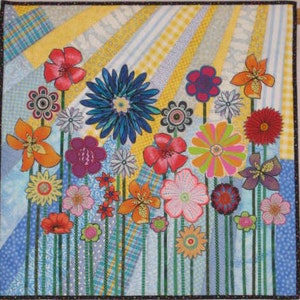 Floral patchwork wall quilt with bright flowers, butterflies, and striped background