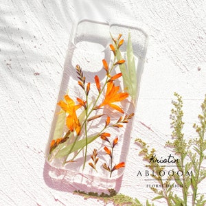Pressed real flower phone case with clear background and orange dried floral design