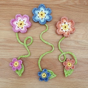 Crochet flower bookmark set with small blossoms, stems, and leaf details