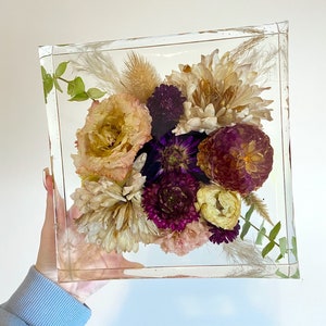 Framed preserved flower bouquet with purple and peach dried blossoms