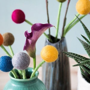 Big felt wool flower with purple petals and small felt pom blossoms on stems