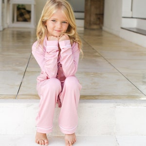 Light pink girls' dress set with bow-front sleeves and ruffled neckline