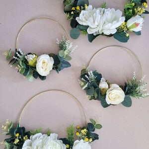 Floral hoop wreath set with white roses, green leaves, and small blue accents