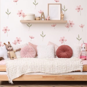 Pastel flower wall stickers with pink blooms and green leaves on a bedroom wall
