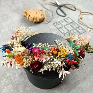 Dried flower bridal crown with multicolor blooms and greenery on black headband