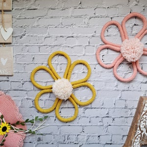Crochet flower wall hanging with pink and yellow blossoms and loop for hanging
