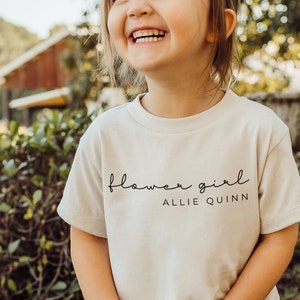 White toddler T-shirt with 'flower girl' and 'ALLIE QUINN' text print