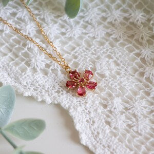 Gold chain necklace with red crystal cherry blossom flower pendant