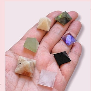 Small crystal mini pyramids set in assorted colors held in hand