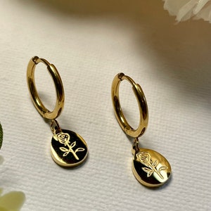 Gold dainty huggie earrings with leaf-and-flower drop charm