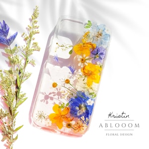 Pressed flower phone case with clear background and blue yellow floral accents