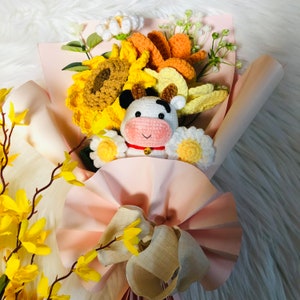 Crochet flower bouquet with sunflower tulip blooms and small crocheted mouse ornament