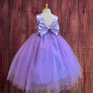 Lilac tulle ball gown with oversized bow and sequin speckle