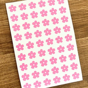 Mini flower sticker sheet with small pink five-petal flowers on white backing