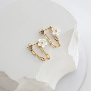 Gold plated flower dangle earrings with white petals and link chain drops