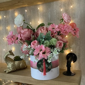 Blush hat box with pink and white flowers in a white round container