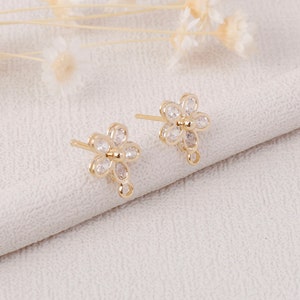 Small gold flower stud earrings with clear rhinestone petals, post back