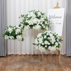 Artificial wedding welcome floral arrangement: white and green flowers on two stands