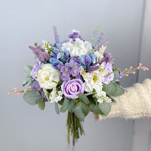 Dusty purple and lavender bridal bouquet with roses, hydrangea, peonies, and greenery