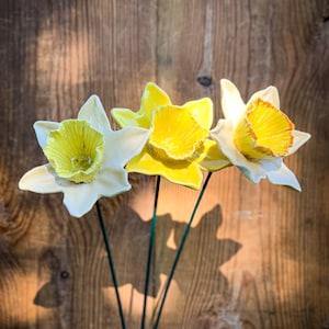 Ceramic daffodil flower ornament with yellow and white blooms and green centers on stems
