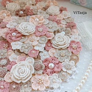 Crochet flower appliqués in cream, pink, and beige with pearl centers
