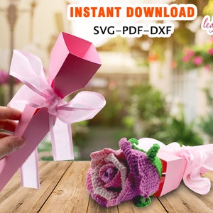 Flower gift package with pink ribbon bow and wrapped treats