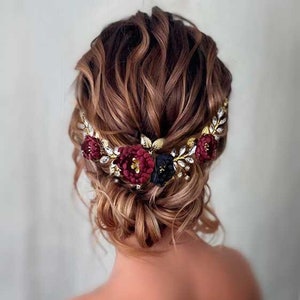 Burgundy flower hair comb with gold-toned leaves and maroon blossoms, bridal style.