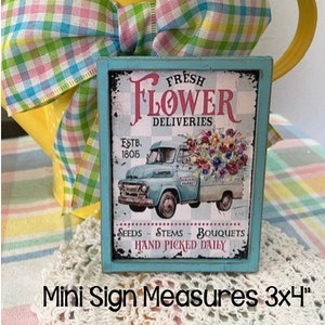 Mini wood sign with 'Fresh Flower Deliveries' typography and truck illustration