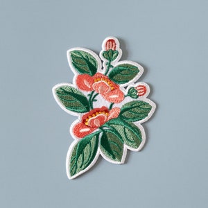 Embroidered flower iron-on patch with red and orange petals and green leaves
