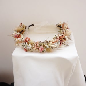 Blush dried flower crown halo with small blooms and greenery, newborn-sized wreath