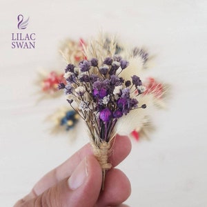 Mini dried flower bouquet with purple and pink blooms in a small twine wrap