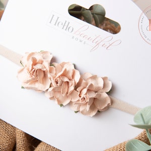 Baby headband with cluster of blush fabric flowers and dark olive bow
