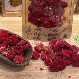 Organic sun-dried pomegranate flowers, whole dried petals in a scoop and pile