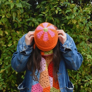 Crocheted winter flower top hat, orange with pink flower detail, slouchy fit
