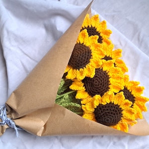 Crochet sunflower bouquet with dark centers, wrapped in kraft paper