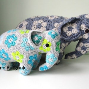 Crocheted elephant figurine with blue and green flower motifs, dark gray ears