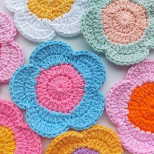 Crochet flower coasters, circular multicolor set with pink and orange centers