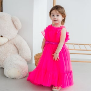 Hot pink sleeveless baby dress with tulle skirt and layered ruffle hem