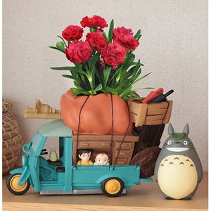 Studio Ghibli Totoro miniature planter diorama with flowers, bus, and Totoro figures