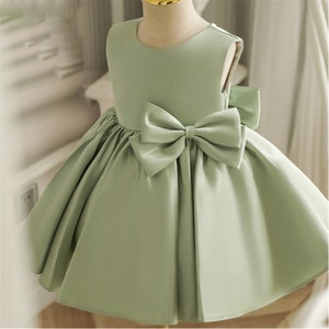 Sage satin baby girl dress with large bow at waist