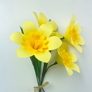 Yellow paper daffodil flower bouquet with tied stems