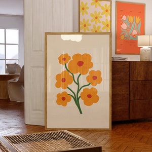 Framed floral wall print with orange flower bouquet on light background and green stems