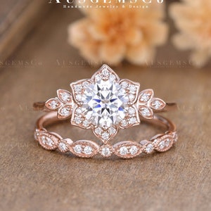 Rose gold halo ring set with round center stone and flower cluster accents