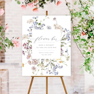 Wildflower floral welcome sign on wooden easel, watercolor blooms and script lettering