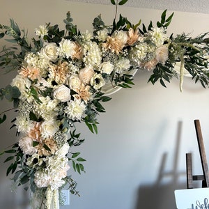 Beige wedding arch floral swag with cream roses and greenery, corner arrangement
