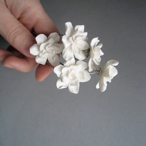 Ivory floral hair pin set with multiple gardenia-style blossoms