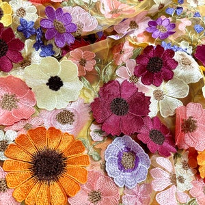 3D floral lace applique fabric with multicolor yellow, pink, and purple flower motifs
